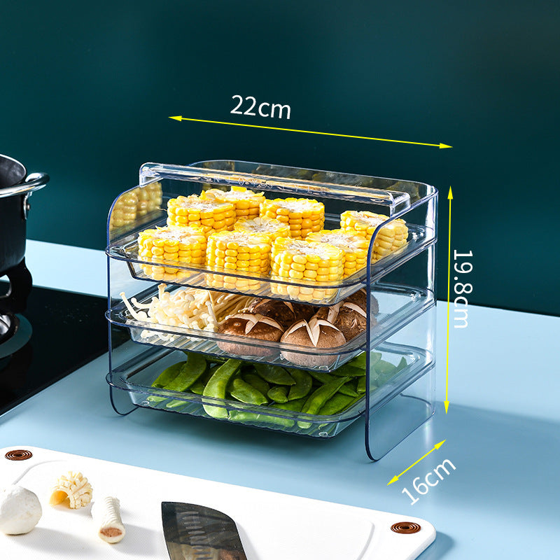 Kitchen pantry portable multi-layer rack with three transparent tiers, displaying corn, mushrooms, and greens.