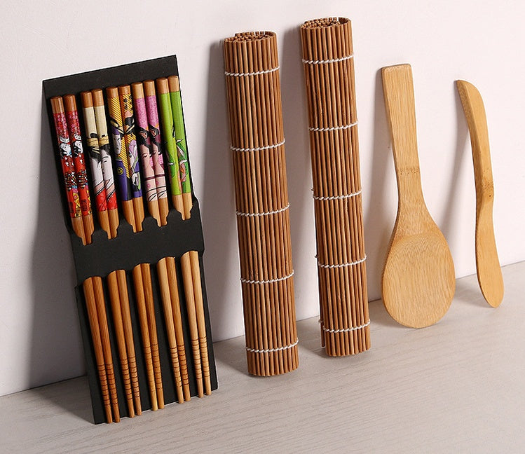 Sushi tool set with chopsticks, bamboo rolling mats, rice paddle, and spreader.