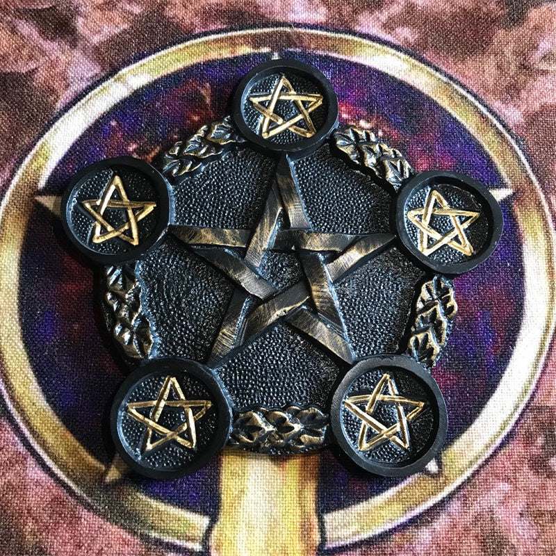 Pentagram candle holder with black resin and gold inlay for altar ceremonies.