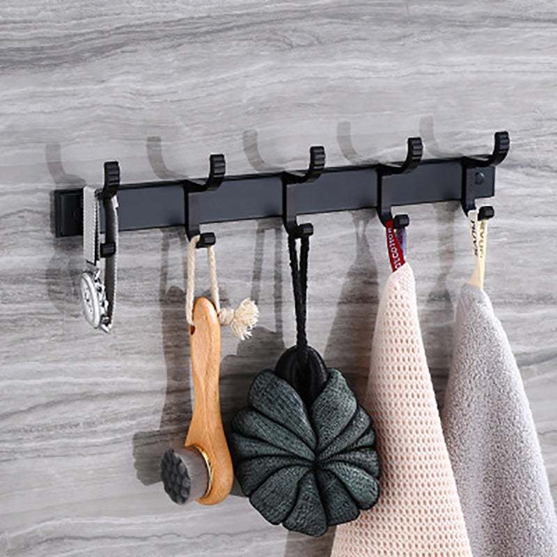 Punch free black bathroom coat hooks on wall with hanging items.