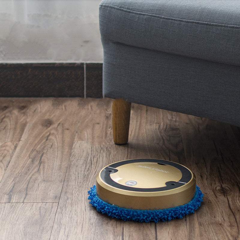 Intelligent automatic sweeping robot on wooden floor, silver-gray with blue cleaning pad.
