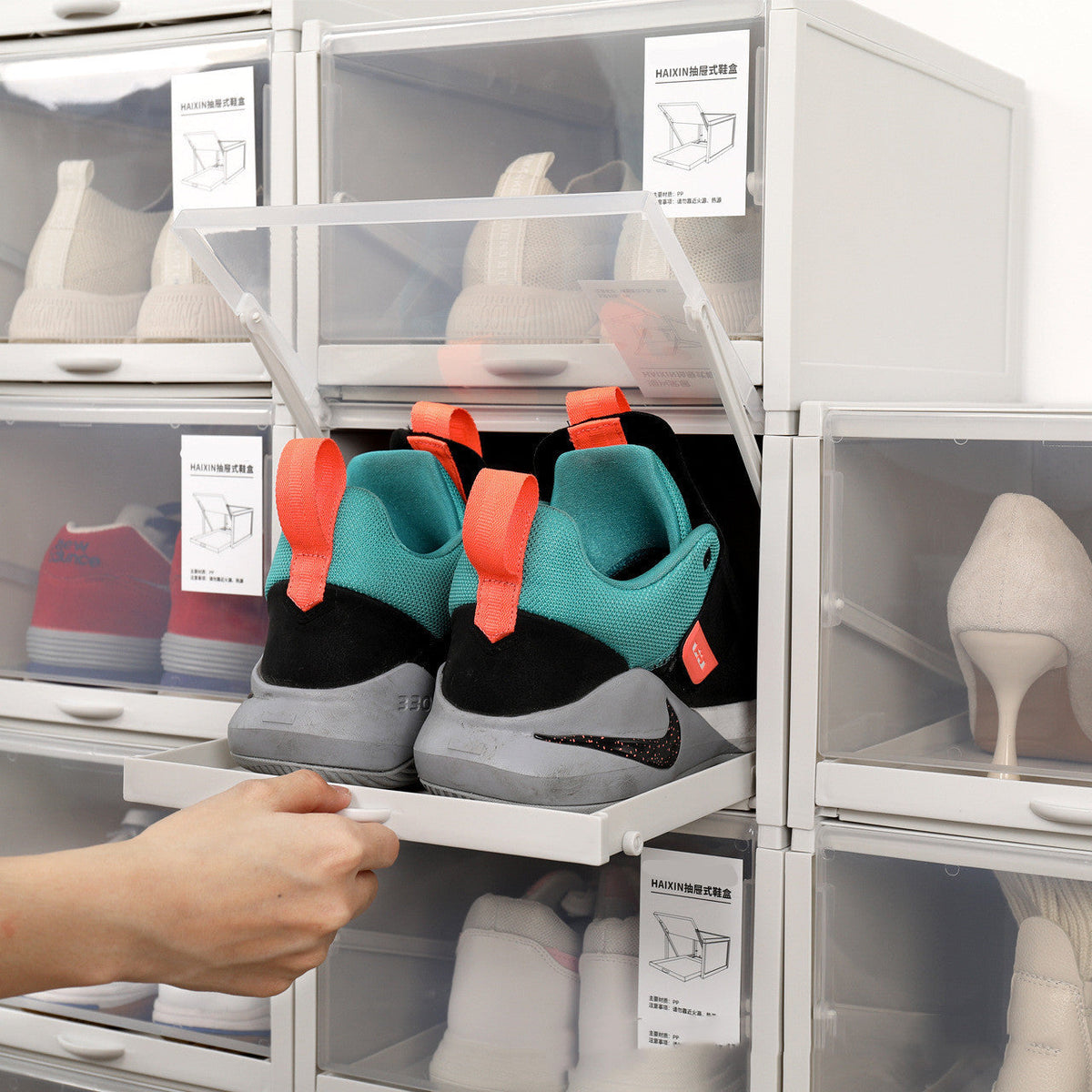 Modern dust-proof shoe cabinet with transparent drawers storing various footwear.