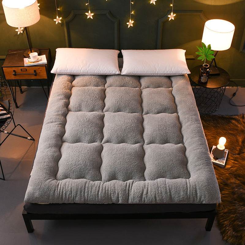 Children's mattress quilt with thick lamb wool in gray, polyester fiber filling, displayed on a bed.