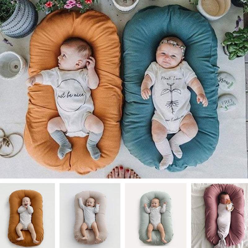 Newborns in portable cotton nest cribs in various colors.