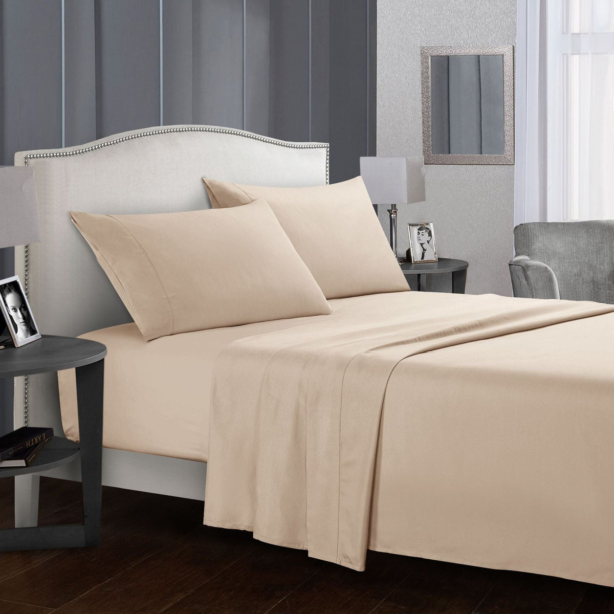 Four-piece bed sheet set on a made bed with pillows in a modern bedroom.