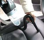 Auto vacuum cleaner 12V 120W being used on car seat.