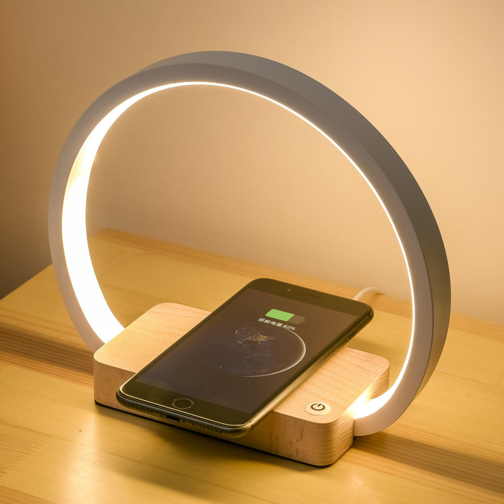 Multifunctional table lamp with wireless charging and eye protection lighting.
