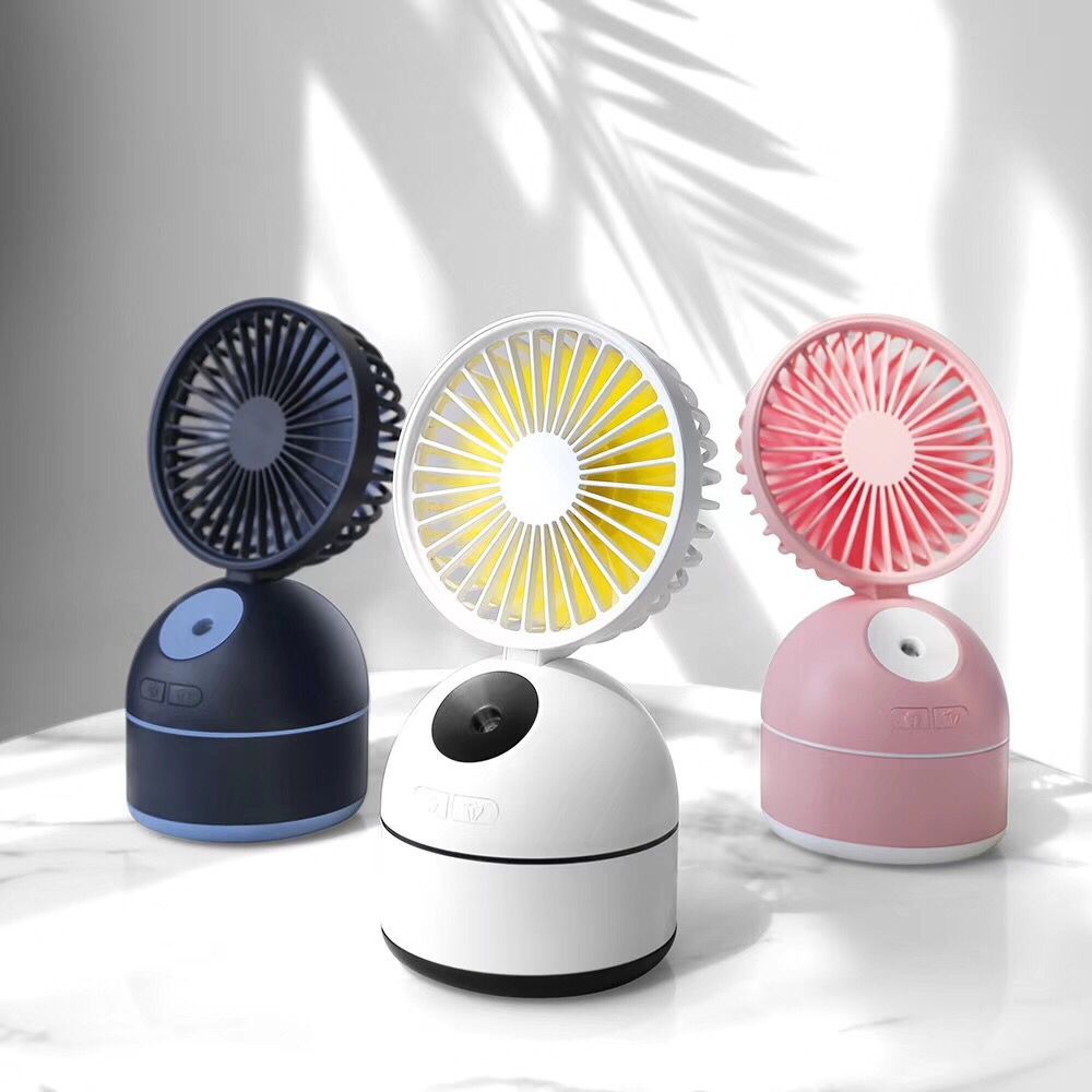 Three fan humidifiers in black, white, and pink on a marble surface.