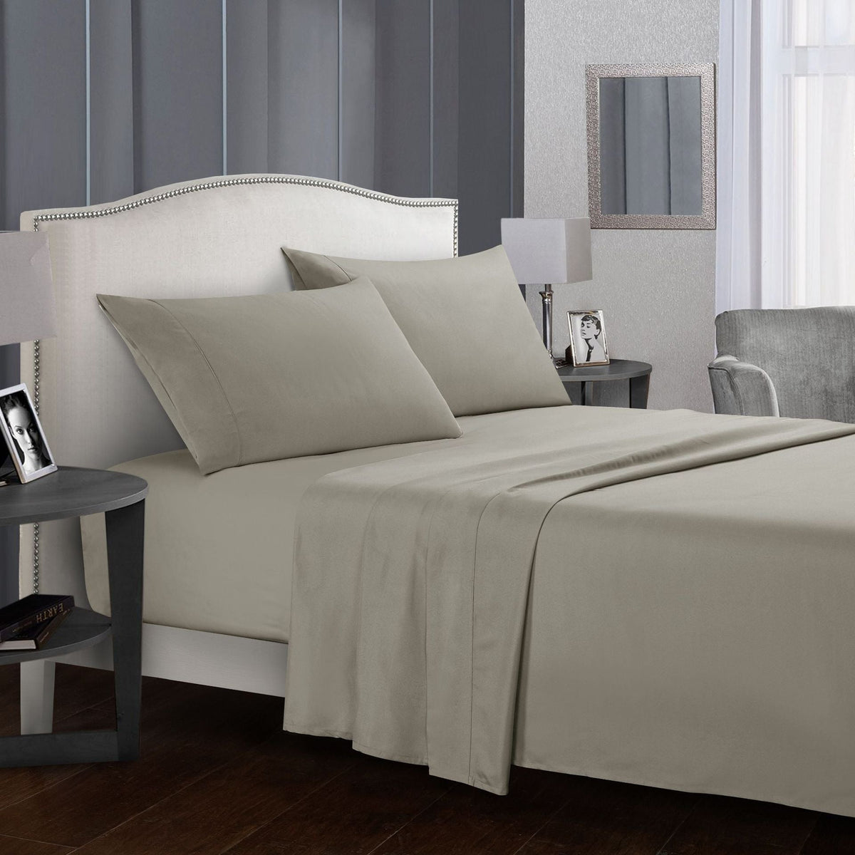 Four-piece bed sheet set on a modern bed in neutral tones.