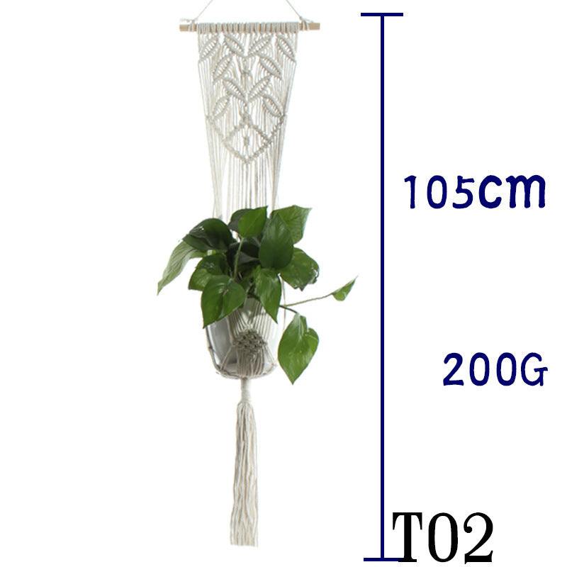 Beige cotton rope plant hanger with decorative design holding green plant.