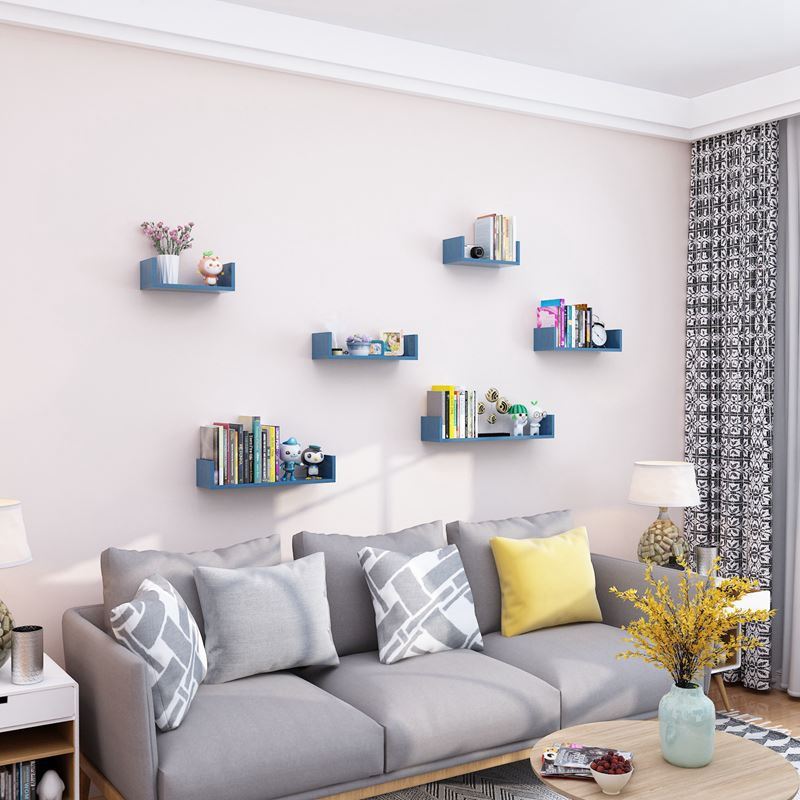 Wooden wall hanging shelves in a living room with modern decor.