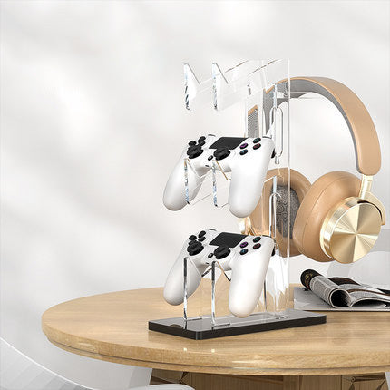Handle support base controller stand with dual-layer acrylic display holding gaming controllers and headphones on a table.