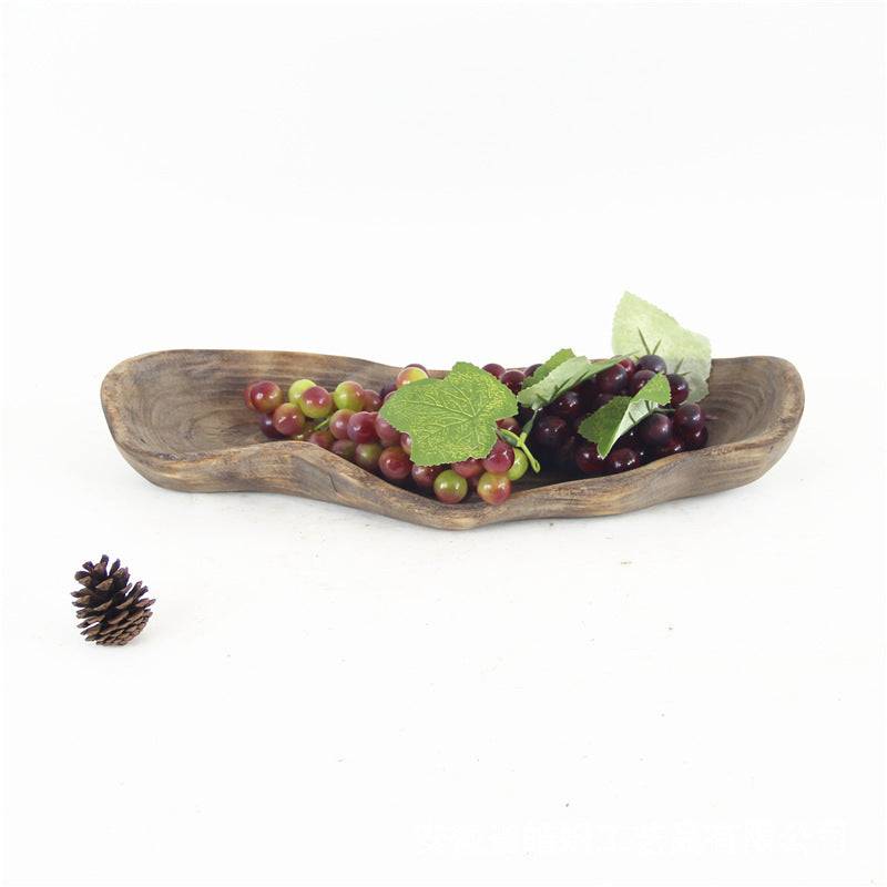 Handmade wooden decorative platter displaying assorted fruits.
