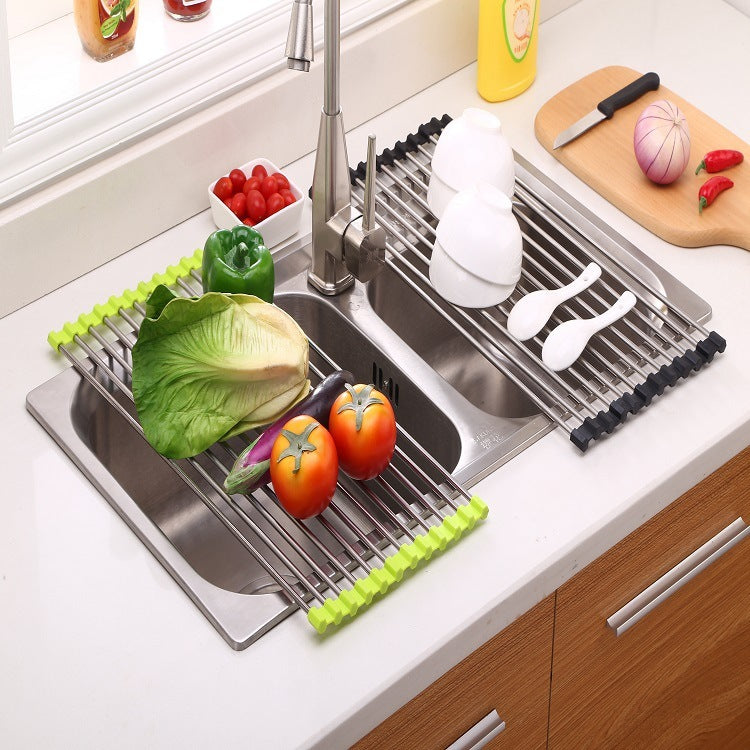 Folding stainless steel kitchen drain sink rack with fruits and utensils.