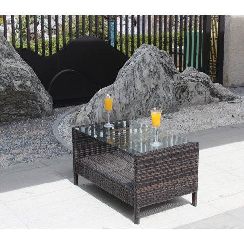 Outdoor coffee table with clear tempered glass top, brown wicker design.