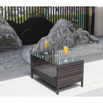Outdoor coffee table with clear tempered glass top, brown wicker design.