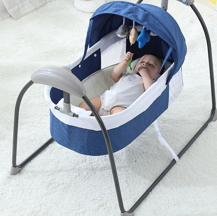Electric rocking bed for babies in blue with a tent, suitable for ages 0-12 months, on a carpeted floor.